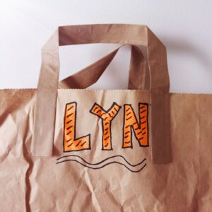 Brown paper bag bearing the name Lyn